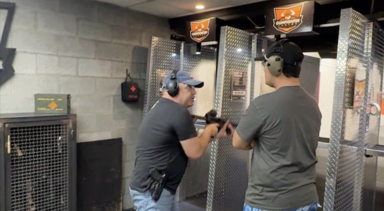 Instrutor orientando participante na linha de tiro do Gunfighter Canyon